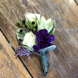 Small purple and white boutonniere with berries and leaves
