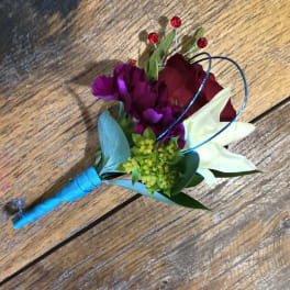 Small boutonniere with red, purple, and white flowers