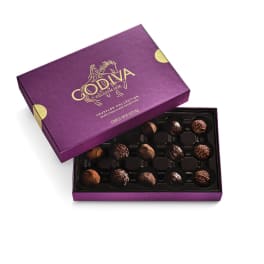Open purple box of assorted chocolate truffles with lid partially covering the tray