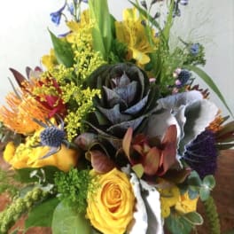 Mixed bouquet with yellow roses and colorful tropical blooms