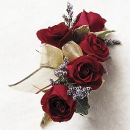 Small bouquet of red roses with gold ribbon and tiny filler flowers