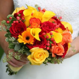 Bouquet of red and yellow roses with orange flowers and berries
