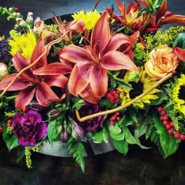Mixed bouquet with lilies, roses, sunflowers, and purple blooms