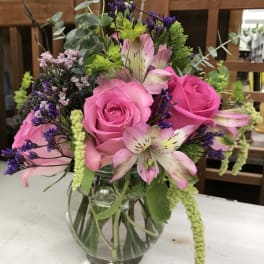 Pink roses and alstroemeria in a clear glass vase