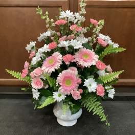 Pink and white mixed flower arrangement in a white vase