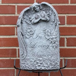 Gray memorial plaque with angel relief and the words In Loving Memory
