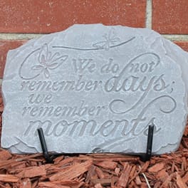 Decorative stone plaque with the words "We do not remember days, we remember moments."
