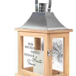 Wooden memorial lantern with a metal top and engraved tribute text