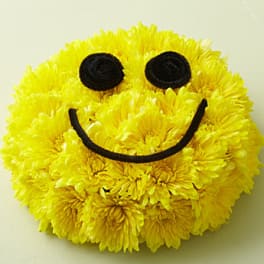 Yellow chrysanthemum arrangement shaped like a smiling face