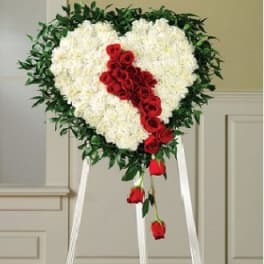 Heart-shaped floral standing spray with white flowers and red roses