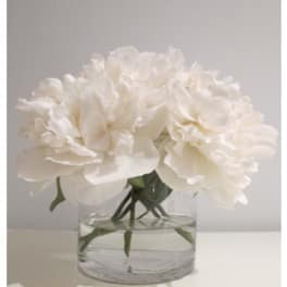White peony bouquet in a clear glass vase