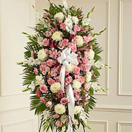 Tall pink and white funeral spray with a white ribbon