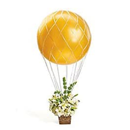 Gold balloon above a small flower basket with white blooms
