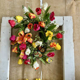 Colorful tulip wreath with a plaid bow on a white frame