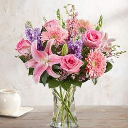 Pink and purple mixed bouquet in a clear glass vase