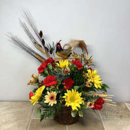 Basket arrangement with red and yellow flowers and a decorative rooster topper