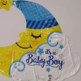 Moon-shaped baby boy balloon with a smiling face and blue hat