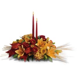Autumn floral centerpiece with two red taper candles