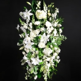 Tall white floral spray with lilies and mixed blooms