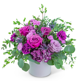 Purple and pink rose bouquet in a white vase