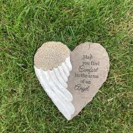 Heart-shaped memorial stone with an angel wing and condolence message