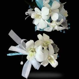 A matching set of white dendrobium orchid corsage and boutonniere set