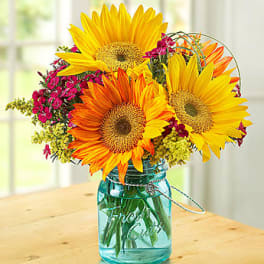 Sunflower bouquet in a blue glass mason jar