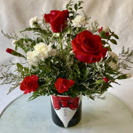 Red roses and white carnations in a tuxedo-themed vase