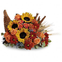 Autumn floral arrangement with sunflowers, roses, and daisies