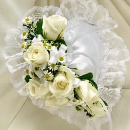 White rose bouquet with small daisy-like flowers and a satin ribbon