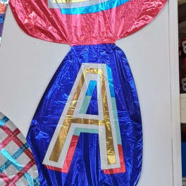 Foil balloon letters spelling "DAD" in red, blue, and teal