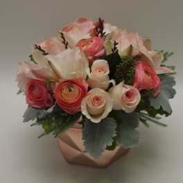 Pink and cream mixed flower arrangement in a copper vase