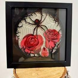 Framed spider decoration with red rose accents