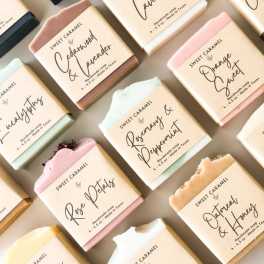 Assorted pastel soap bars in labeled paper wraps