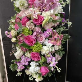 Large pink and white floral standing spray on an easel