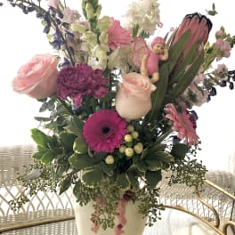 Tall mixed bouquet in a white vase with pink and white flowers