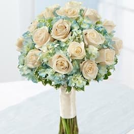 Cream rose bouquet with pale blue hydrangeas and a wrapped stem