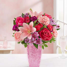 Pink and red mixed bouquet in a pink vase
