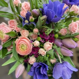 Bouquet of pink roses with purple tulips and blue flowers