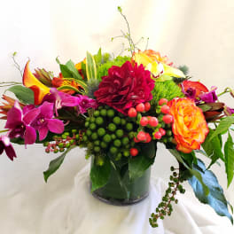 Colorful mixed floral arrangement in a glass vase