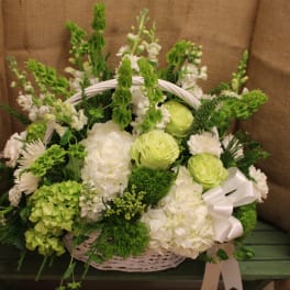 White and green flower basket with a ribbon bow