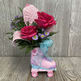 Pink roses and purple daisies arranged in a pink roller skate container