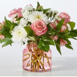 Pink roses and white chrysanthemums in a pink glass vase
