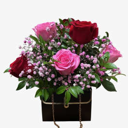Bouquet of red and pink roses in a black gift box