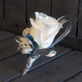 White rose boutonniere with silver ribbon and wire accents