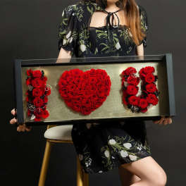 Framed red rose arrangement spelling "I LOVE U"