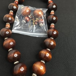 Wood bead necklace with matching earrings in a plastic bag