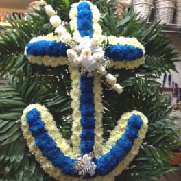 Blue and white floral cross wreath with white ribbon accents