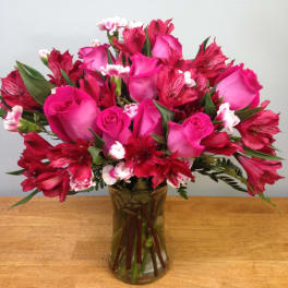 Pink roses and red alstroemeria in a glass vase