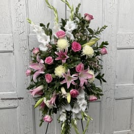 Standing floral spray with pink roses, white lilies, and white mums